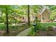 Backyard featuring a winding gravel path, mature trees, and lush greenery at 7212 Donneeford Rd, Wake Forest, NC 27587