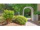 Beautiful backyard garden area featuring a brick path and a white garden arch at 7212 Donneeford Rd, Wake Forest, NC 27587