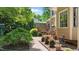 Backyard with a brick walkway, mature trees, and an elevated deck area at 7212 Donneeford Rd, Wake Forest, NC 27587