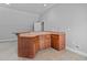 The wet bar features beautiful wood cabinetry, tile floor, and modern fixtures at 7212 Donneeford Rd, Wake Forest, NC 27587