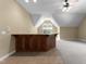 Finished basement space with carpet, a wet bar, neutral paint and a window with natural light at 7212 Donneeford Rd, Wake Forest, NC 27587