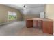 Finished basement space featuring a wet bar with cabinetry, neutral paint and carpet, and a window at 7212 Donneeford Rd, Wake Forest, NC 27587