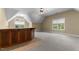 Finished basement space with carpet, a wet bar, neutral paint and a window with natural light at 7212 Donneeford Rd, Wake Forest, NC 27587