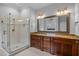 Bright bathroom featuring double vanity and marble countertop and a glass enclosed shower at 7212 Donneeford Rd, Wake Forest, NC 27587