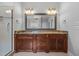 Bathroom with a large vanity, granite countertop, and framed mirror with sconce lighting at 7212 Donneeford Rd, Wake Forest, NC 27587