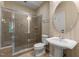 Bathroom featuring seamless shower with glass door and a pedestal sink with round mirror at 7212 Donneeford Rd, Wake Forest, NC 27587
