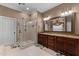 Bathroom featuring a glass enclosed shower, granite countertop vanity, and decorative mirror at 7212 Donneeford Rd, Wake Forest, NC 27587