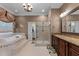 Luxurious bathroom with a soaking tub, walk-in shower, and and vanities at 7212 Donneeford Rd, Wake Forest, NC 27587