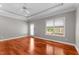 Bright bedroom featuring hardwood floors, recessed lighting, and backyard access at 7212 Donneeford Rd, Wake Forest, NC 27587
