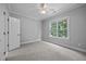 Bedroom with neutral walls, carpet, ceiling fan, and a large window overlooking nature at 7212 Donneeford Rd, Wake Forest, NC 27587