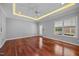 A large bedroom with hardwood floors features natural lighting and tray ceilings at 7212 Donneeford Rd, Wake Forest, NC 27587
