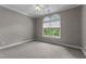 Bedroom with gray walls, neutral carpet, ceiling fan and arched windows at 7212 Donneeford Rd, Wake Forest, NC 27587