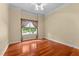 Empty bedroom with hardwood floors, crown molding, and window with floral patterned curtains at 7212 Donneeford Rd, Wake Forest, NC 27587