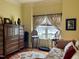 Bedroom featuring floral accents, hardwood floors, a window seat, and dark wood furniture at 7212 Donneeford Rd, Wake Forest, NC 27587