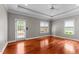 Spacious bedroom with hardwood floors, recessed lighting, and windows overlooking the outdoors at 7212 Donneeford Rd, Wake Forest, NC 27587