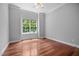 Bright bedroom features hardwood floors and a large window offering plenty of natural light at 7212 Donneeford Rd, Wake Forest, NC 27587