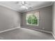 Bedroom with neutral carpet, overhead fan, and window with green view at 7212 Donneeford Rd, Wake Forest, NC 27587