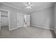 Neutral bedroom with carpet, ceiling fan, and white trim doors to a walk-in closet and bathroom at 7212 Donneeford Rd, Wake Forest, NC 27587