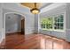 An empty dining room features natural lighting, hardwood floors, and custom trim at 7212 Donneeford Rd, Wake Forest, NC 27587