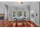 Bright breakfast nook with a bay window, hardwood floors, and a view of the backyard at 7212 Donneeford Rd, Wake Forest, NC 27587