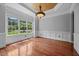 An empty dining room with natural lighting, hardwood floors, and custom trim at 7212 Donneeford Rd, Wake Forest, NC 27587
