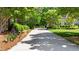 Long driveway leads to a home with lush landscaping and mature trees in a peaceful setting at 7212 Donneeford Rd, Wake Forest, NC 27587
