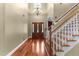 Grand foyer featuring hardwood floors, staircase, chandelier, and stained glass window at 7212 Donneeford Rd, Wake Forest, NC 27587