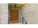 Charming front entrance with a stained wood door and brick facade at 7212 Donneeford Rd, Wake Forest, NC 27587