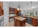 An open concept kitchen features a kitchen island, granite countertops, and custom cabinets at 7212 Donneeford Rd, Wake Forest, NC 27587