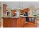 Gourmet kitchen with dark wood cabinets, granite countertops, and stainless steel appliances at 7212 Donneeford Rd, Wake Forest, NC 27587