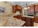 Gourmet kitchen featuring granite countertops, custom cabinets, and stainless steel appliances at 7212 Donneeford Rd, Wake Forest, NC 27587