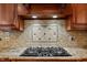 A custom kitchen backsplash accents a gas cooktop at 7212 Donneeford Rd, Wake Forest, NC 27587