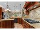 Spacious kitchen featuring custom cabinets, granite counters, and modern appliances at 7212 Donneeford Rd, Wake Forest, NC 27587