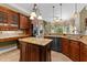 Well-appointed kitchen with wood cabinets, granite countertops, and a center island with a sink at 7212 Donneeford Rd, Wake Forest, NC 27587