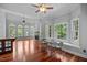 Open-concept living area with hardwood floors, ample windows, a fireplace, and a seamless connection to the kitchen at 7212 Donneeford Rd, Wake Forest, NC 27587