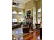 Cozy living room showcasing a fireplace, hardwood floors and large windows at 7212 Donneeford Rd, Wake Forest, NC 27587