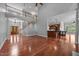 Spacious living area with staircase, hardwood floors, and a view into the kitchen, creating a modern open floor plan at 7212 Donneeford Rd, Wake Forest, NC 27587