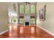 Bright living room features hardwood floors, a fireplace, and large windows for ample natural light at 7212 Donneeford Rd, Wake Forest, NC 27587