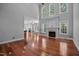 Inviting living room featuring large windows and a fireplace, offering a cozy atmosphere and ample natural light at 7212 Donneeford Rd, Wake Forest, NC 27587