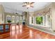 Open living space features a cozy window seat, fireplace, and beautiful hardwood floors throughout at 7212 Donneeford Rd, Wake Forest, NC 27587