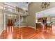 Open concept living area with hardwood floors, staircase, and kitchen bar at 7212 Donneeford Rd, Wake Forest, NC 27587