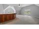 Open living room features a bar, plush carpet, lots of light, and neutral paint at 7212 Donneeford Rd, Wake Forest, NC 27587