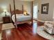 Main bedroom featuring a four-poster bed, and hardwood floors at 7212 Donneeford Rd, Wake Forest, NC 27587