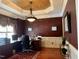 Home office with hardwood floors, wainscoting, large window, and built-in cabinets at 7212 Donneeford Rd, Wake Forest, NC 27587