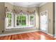 Bright sitting area featuring a window seat with decorative cushions and hardwood floors at 7212 Donneeford Rd, Wake Forest, NC 27587