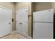 Utility room with two white doors and a white refrigerator at 7212 Donneeford Rd, Wake Forest, NC 27587