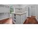 Spacious walk-in closet with custom shelving, drawers, and hardwood flooring at 7212 Donneeford Rd, Wake Forest, NC 27587