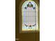 Stained glass window featuring elegant patterns in an arched window frame at 7212 Donneeford Rd, Wake Forest, NC 27587
