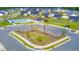 Aerial view of a residential neighborhood with a pool and clubhouse at 73 Windswept Way, Fuquay Varina, NC 27526