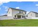 Backyard with outdoor seating, a well-kept lawn, and white fencing at 73 Windswept Way, Fuquay Varina, NC 27526